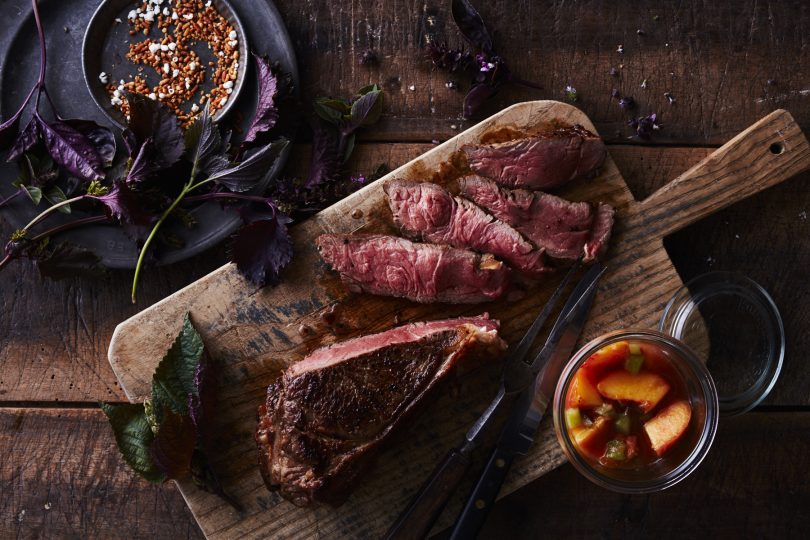 Prime Angus strip steak with peach and greens VUE magazine