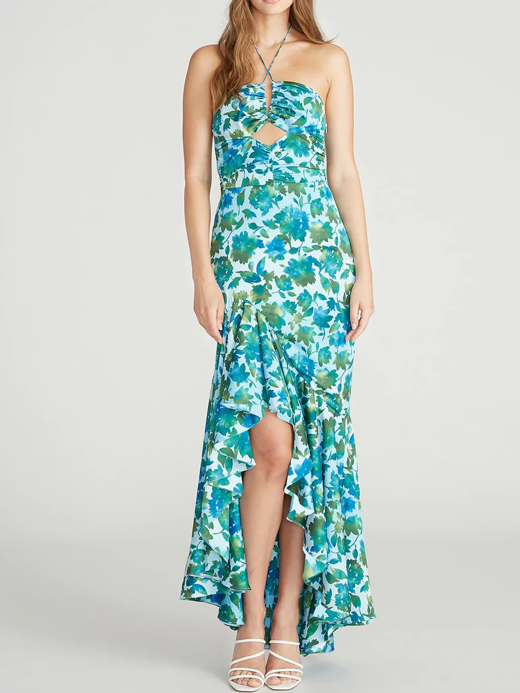 Blue and green floral high-low midi dress. Neckline is halter with keyhole cutout below the bust. There are ruffles around the hem.